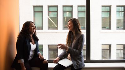 Two property managers sitting on a window ledge