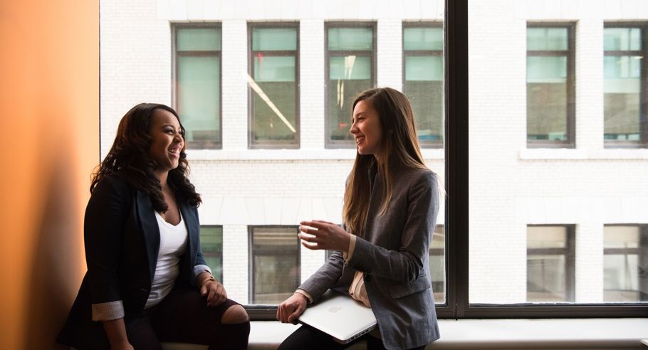 Two property managers sitting on a window ledge