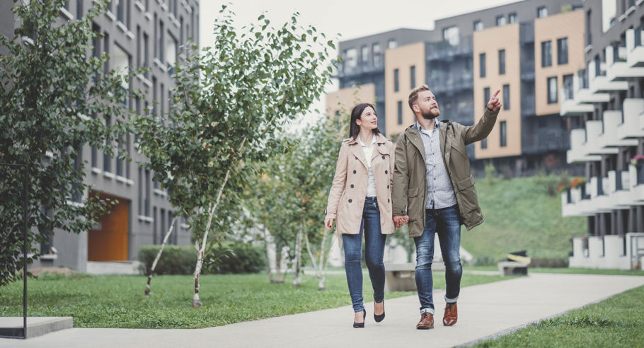 Two people walking down a pathway, one person is pointing