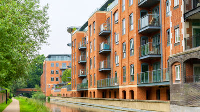 A modern apartment block on the side of a body of water