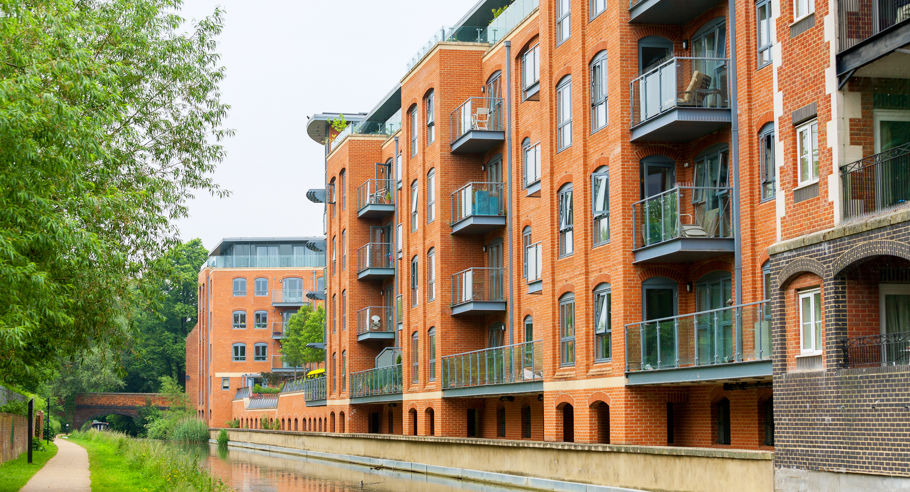 A modern apartment block on the side of a body of water