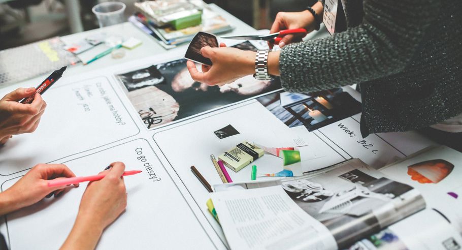 Image of the hands of people working on a magazine