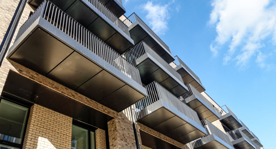 A low angle image of an apartment block's balconies