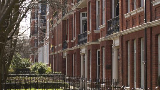 The front gardens of a red brick town house complex