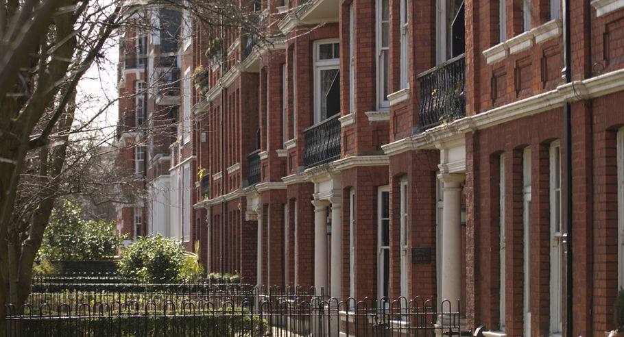 The front gardens of a red brick town house complex