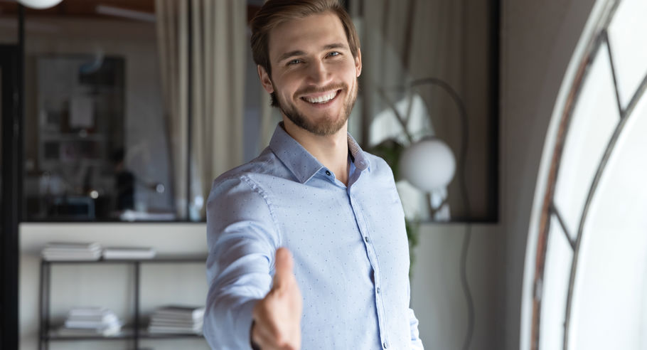 A man extending a hand out for a handshake