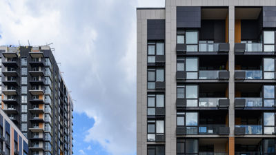 Modern apartment blocks in front of a blue sky