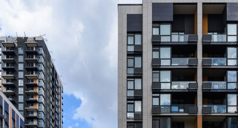 Modern apartment blocks in front of a blue sky