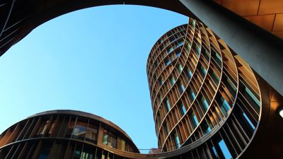 An architectural image of a wave-like building