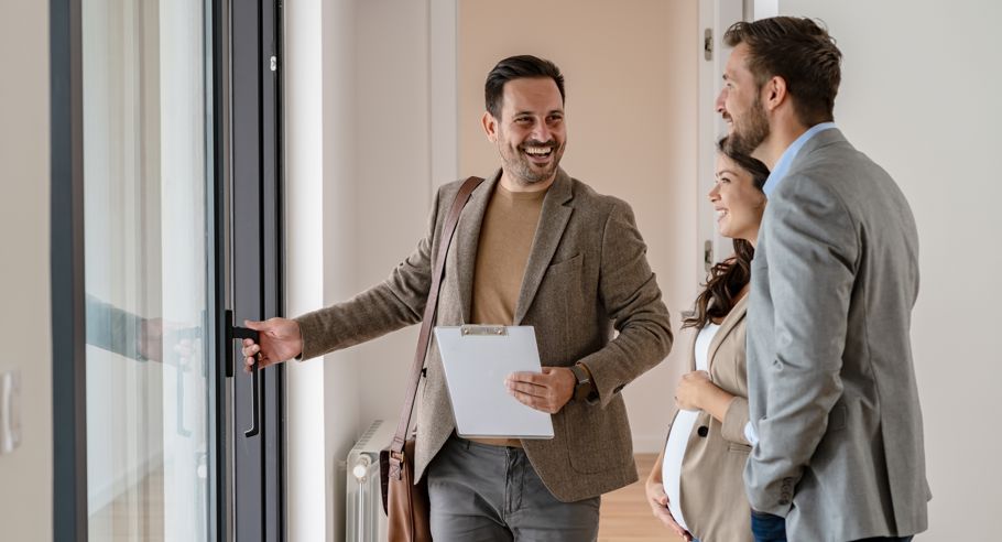 A property manager holding a door in a new apartment