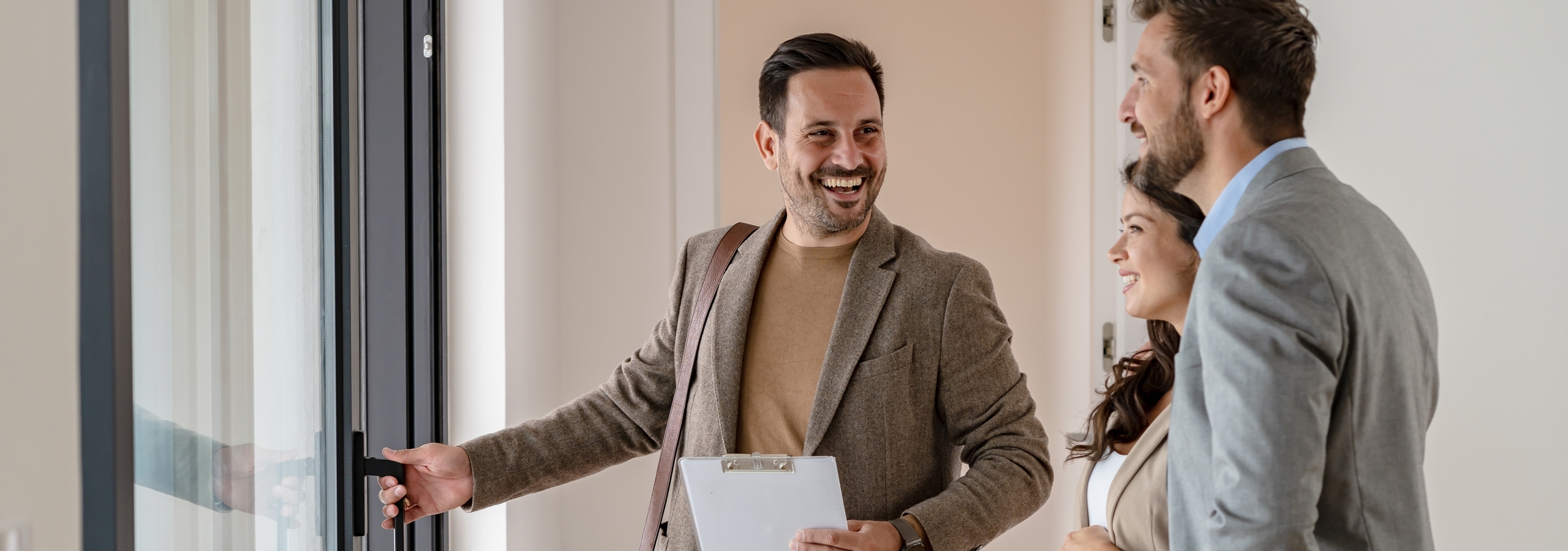 A property manager holding a door in a new apartment