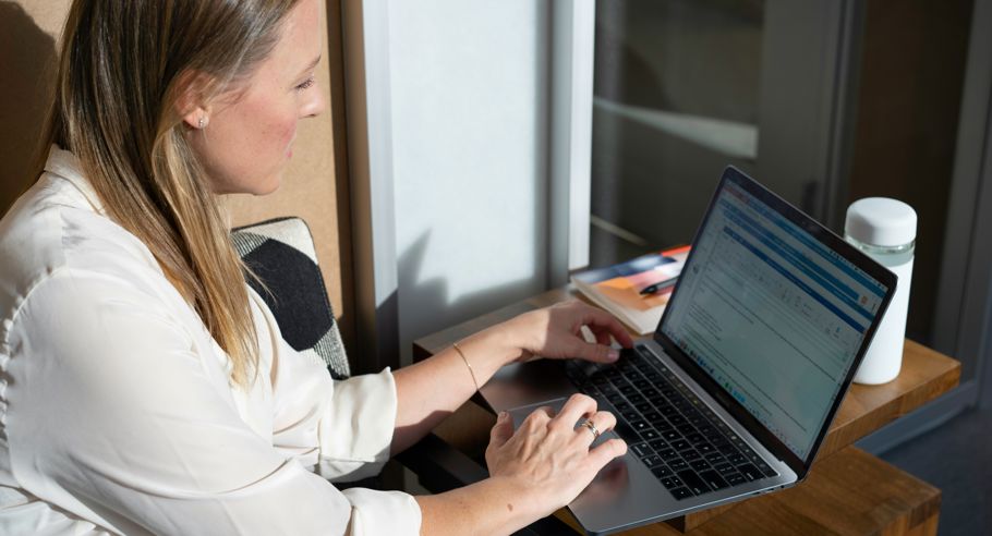 A lady sitting looking at a computer