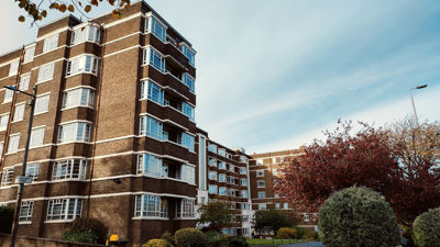 A  low angle image of brown apartment complex from the street