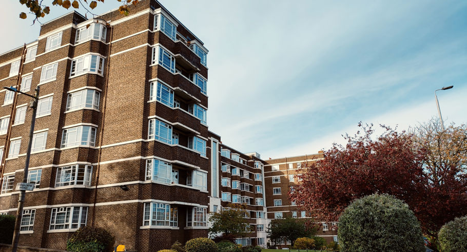 A  low angle image of brown apartment complex from the street